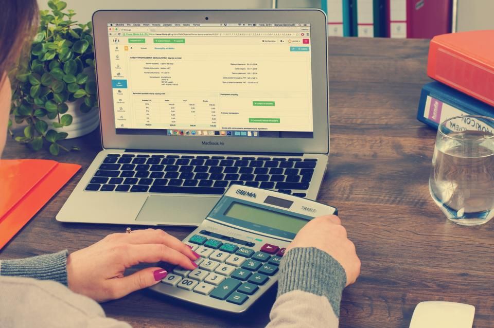 Desk with a calculator, invoices and a notebook