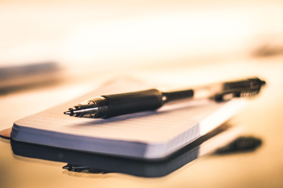 A pen resting on a printed planning notepad